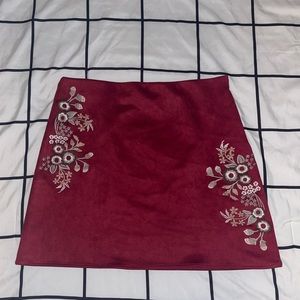 Red short skirt with beautiful detailing.